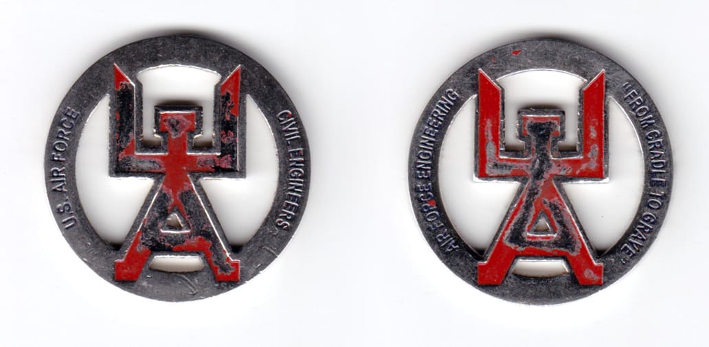 Round shaped coin, silver in color, 1 1/3 inches in diameter.