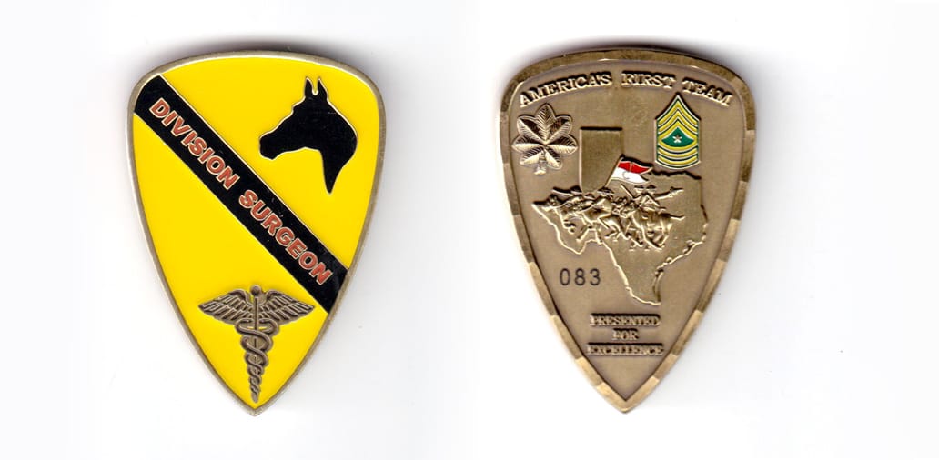 Shield shaped coin, antique brass in color, 2 inches high x 1 1/2 inches wide.