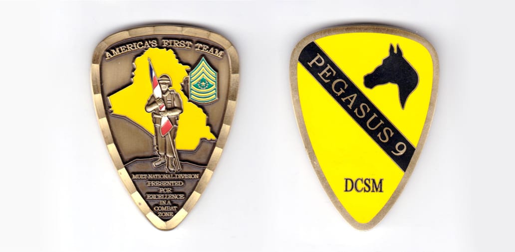 Shield shaped coin, antique brass in color, 2 inches high x 1 1/2 inches wide.