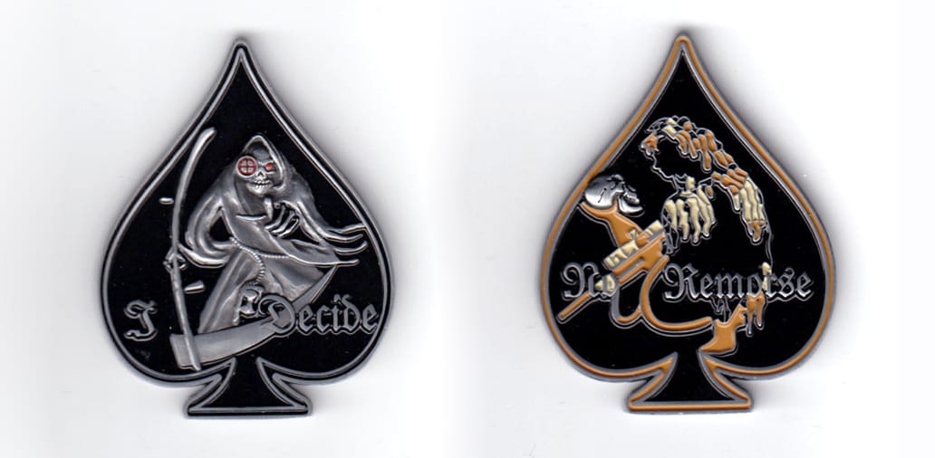Spade (playing cards) shaped coin, pewter in color, 2 inches high x 1 1/2 inches wide.