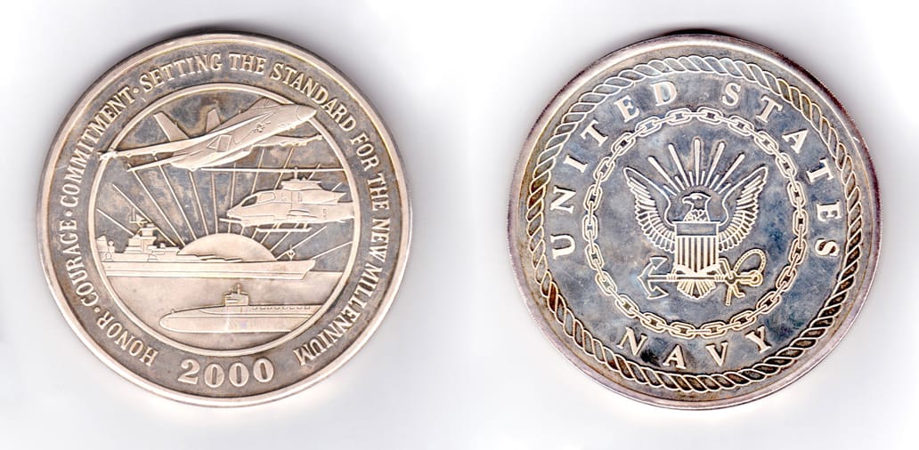 Round shaped coin, siver in color, 3 1/2 inches in diameter.