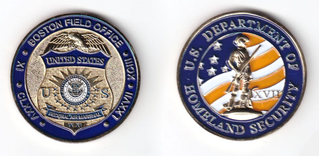 Round shaped coin, brass in color, 1 5/8 inches in diameter.