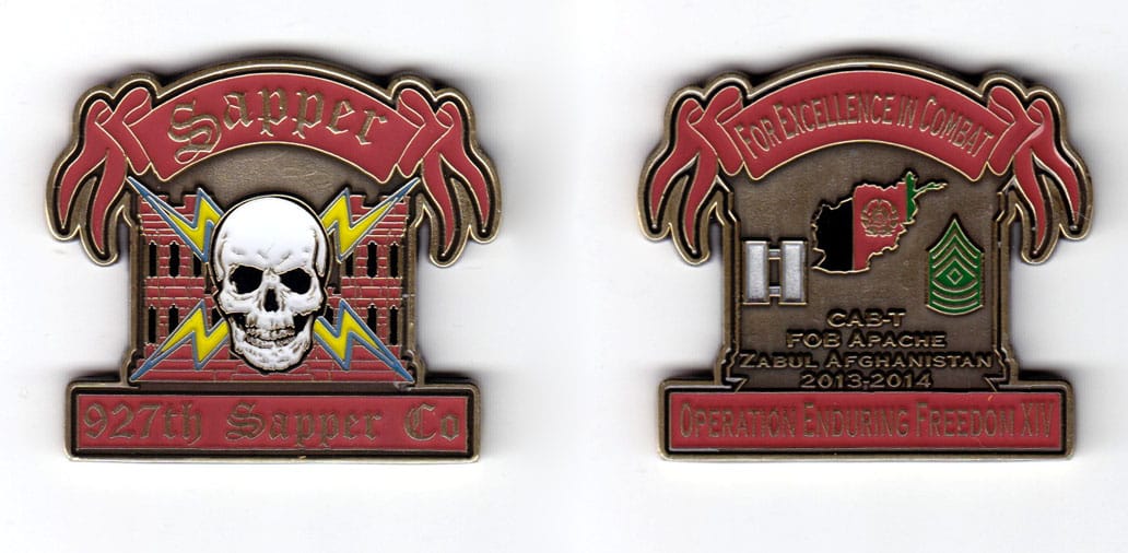 Coin is engineer castle shaped with a wide ribbon banner above and a rectangular banner below, antique brass in color, 1...