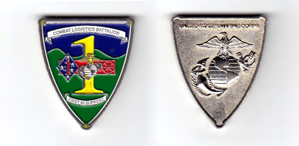 Shield shaped coin, pewter in color, 1 3/4 inches high & 1 1/2 inches wide.