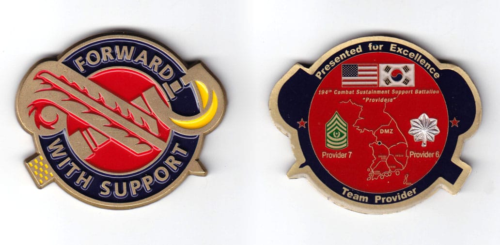 Round shaped coin with crossed quill and micrometer caliper, antique brass in color, 1 7/8 inches high and 2 1/8 inches ...