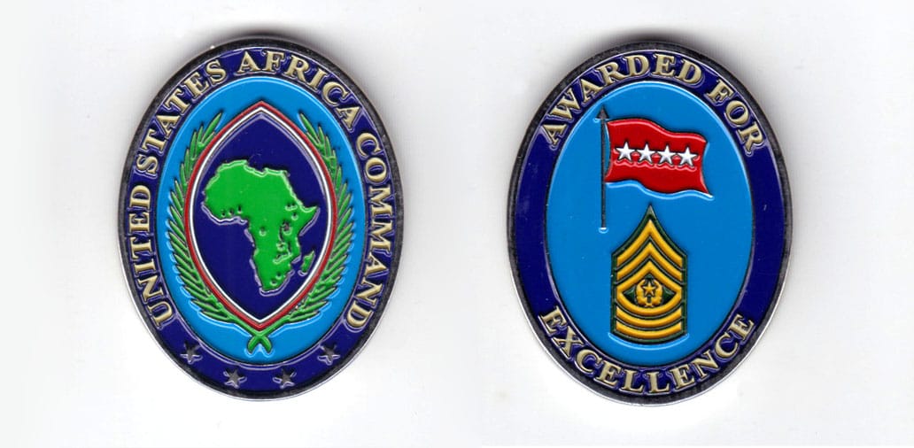 Oval shaped coin, long axis vertical, pewter in color, 1 3/4 inches high, 1 1/4 inches wide.