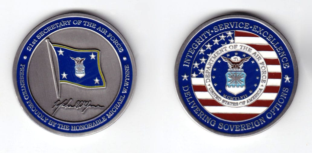 Round shaped coin, pewter in color, 1 7/8 inches in diameter.