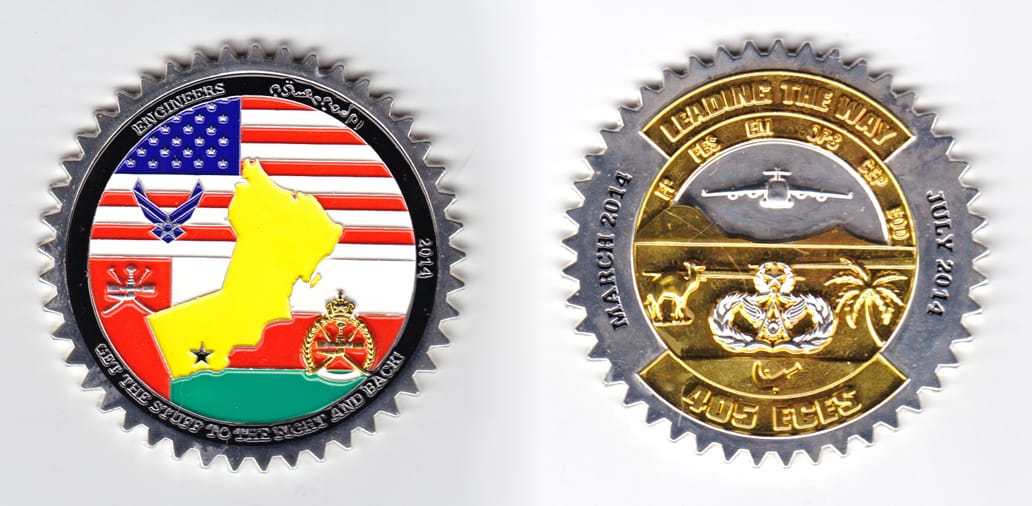 Round sawtoothed shaped coin, silver in color, 2 1/2 inches in diameter.