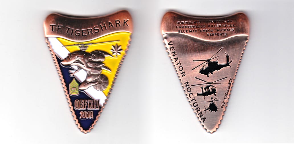 Shark tooth in shape with long axis vertical, copper in color, 2 1/2 inches high x 1 3/4 inches wide.