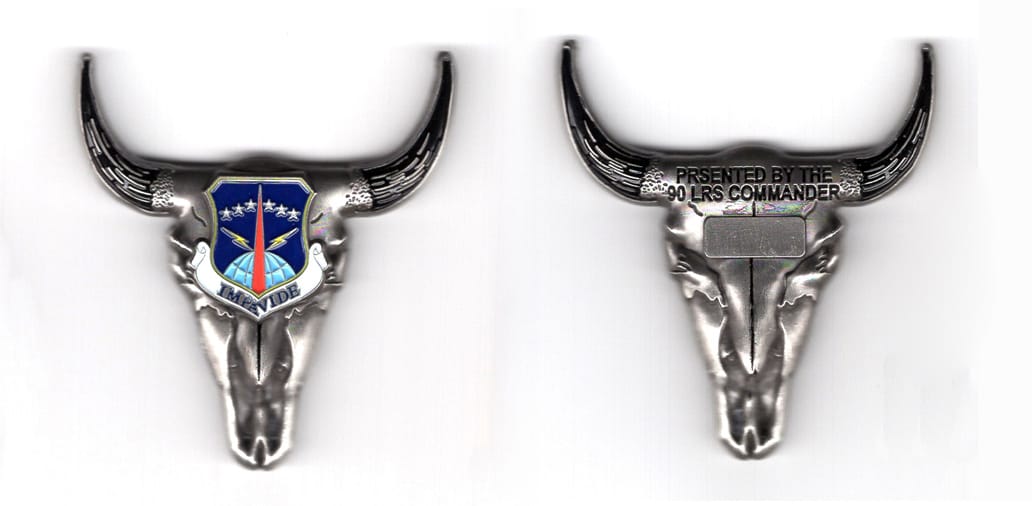 Coin is shaped like a steer's skull, facing forward, pewter in color, 2 1/8 inches high x 2 inches wide.