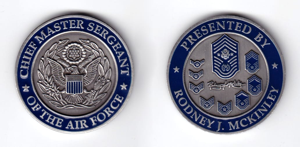 Round shaped coin, pewter in color, 1 5/8 inches in diameter.