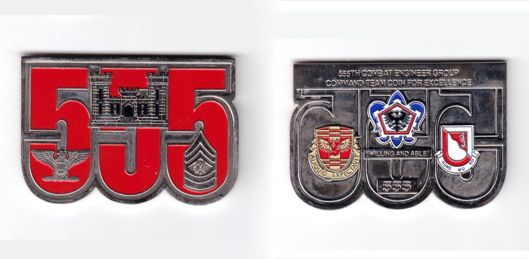 Coin is shaped like the silhouette of three "5's" side by side, pewter in kcolor, 2 inches high x 3 inches wide.