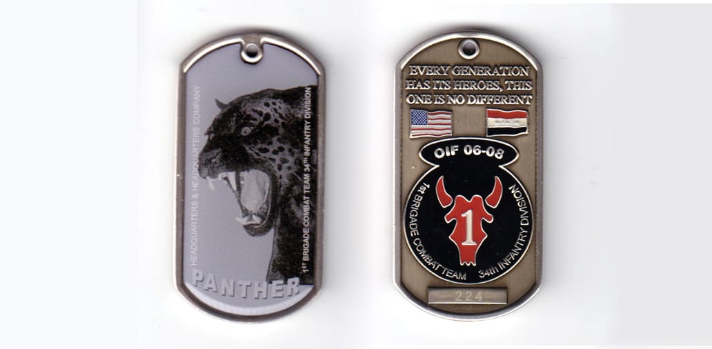 Dog tag shaped coin, pewter in color, 2 1/2 inches high x 1 1/8 inches wide.