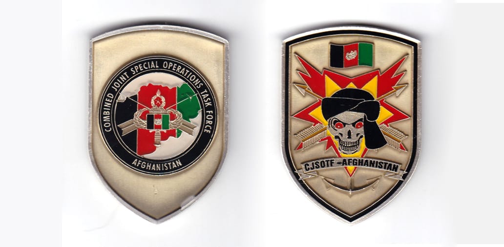 Shield shaped coin, antique brass in color, 2 1/4 inches high x 1 1/2 inches wide.