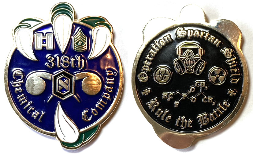 Brass colored, round shaped coin 2 inches in diameter with the primary side being grabbed from behind by 4 claws, 3 at the top and 1 at the bottom, resulting in total coin dimensions of 2 1/2 inches high and 2 inches wide.