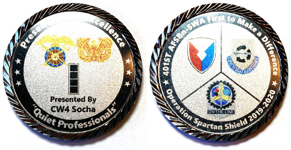 Round shaped coin, 2 inches in diameter, pewter in color.